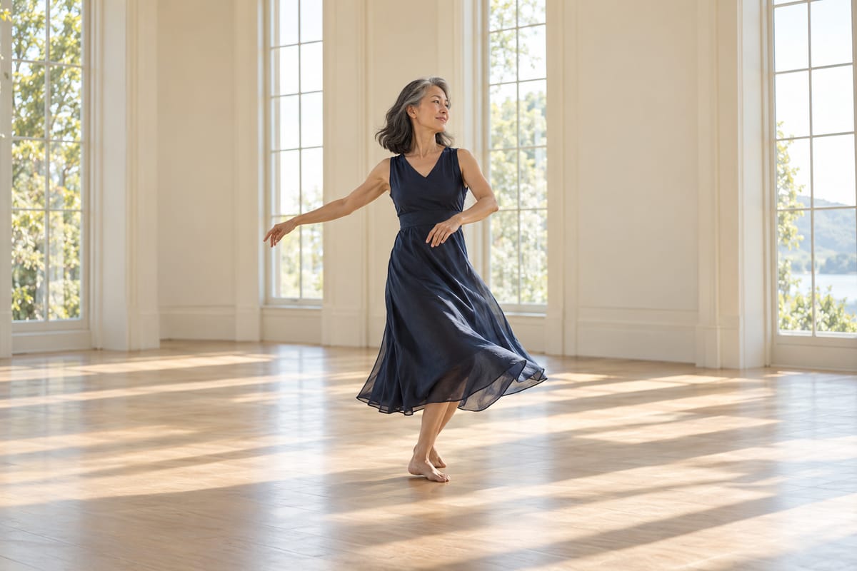 A woman dances alone, mid-turn, in a sunlit room.